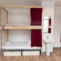 Bed in 8-Bed Dormitory Room with Shared Bathroom