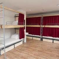 Bed in 6-Bed Dormitory Room with Shared Bathroom