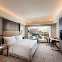 Deluxe King Room with Pool View and Partial Bay View
