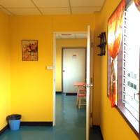 Bed in Dormitory Room with Fan and Shared Bathroom