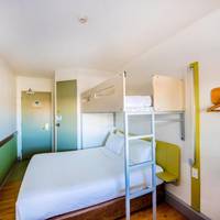 Standard Queen Room with a Single Overhead Bunk Bed